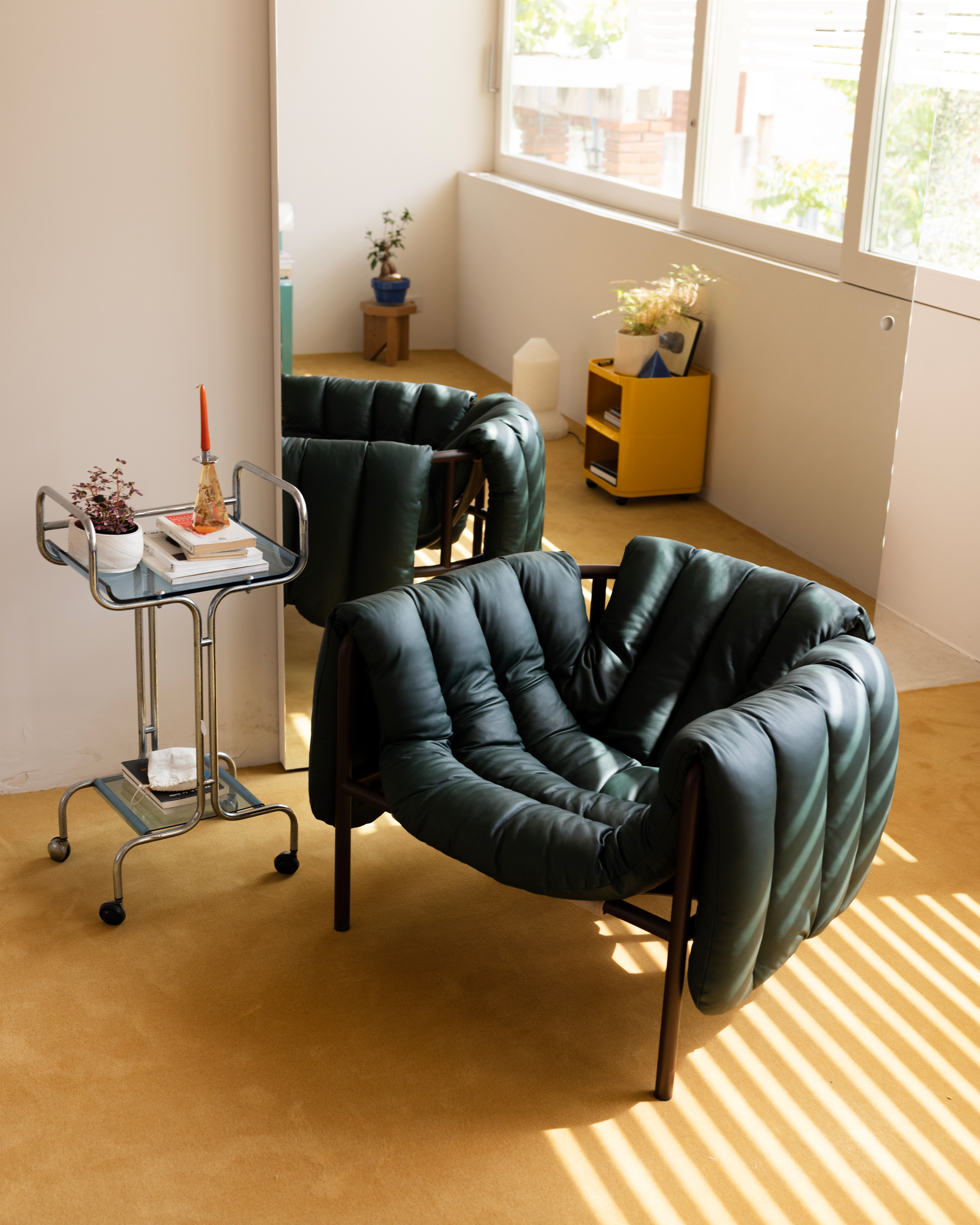 A lifestyle image of a lounge scene featuring Puffy Lounge Chair.