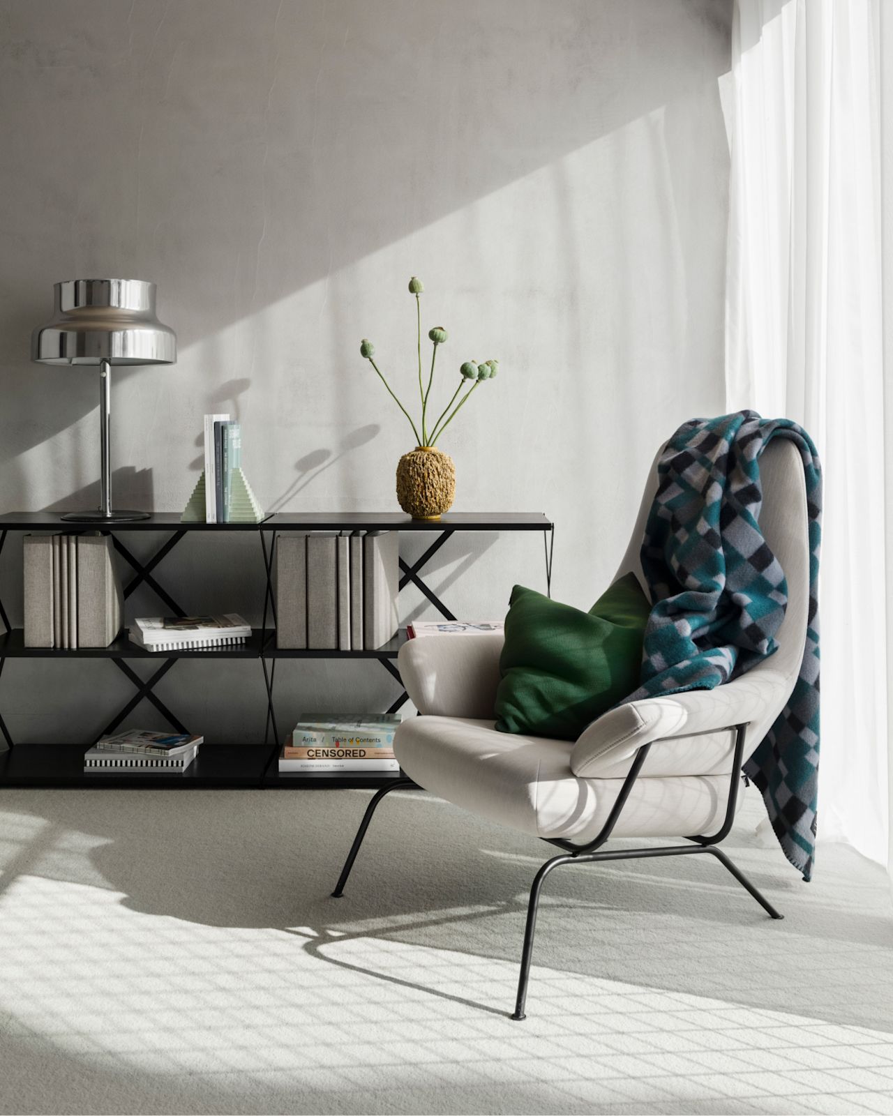 A lifestyle image of a lounge scene featuring Hai Lounge Chair, Lift Shelf, Vienna Throw and Neo Cushion.