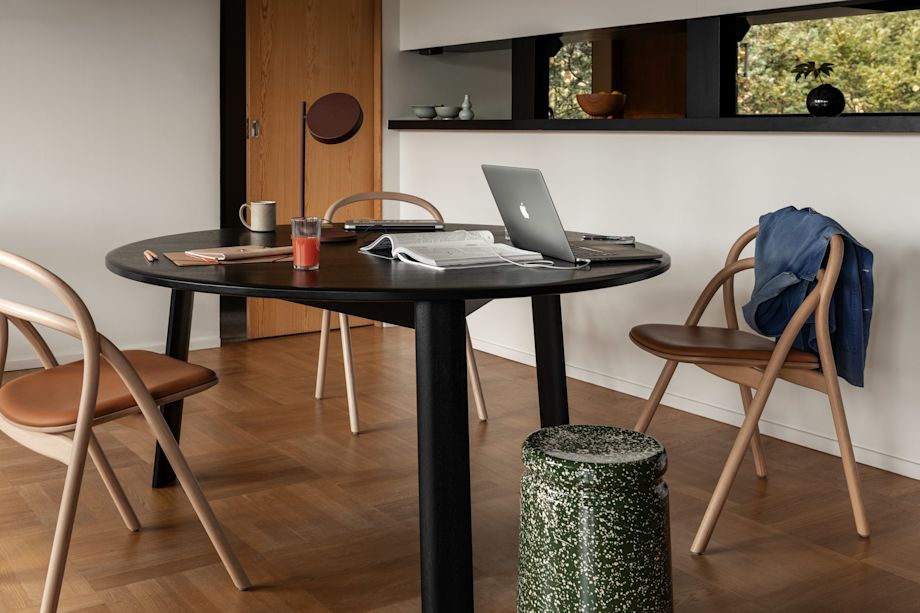 A lifestyle image of a dining room featuring Alle Round Dining Table, Udon Chairs and Last Stool.