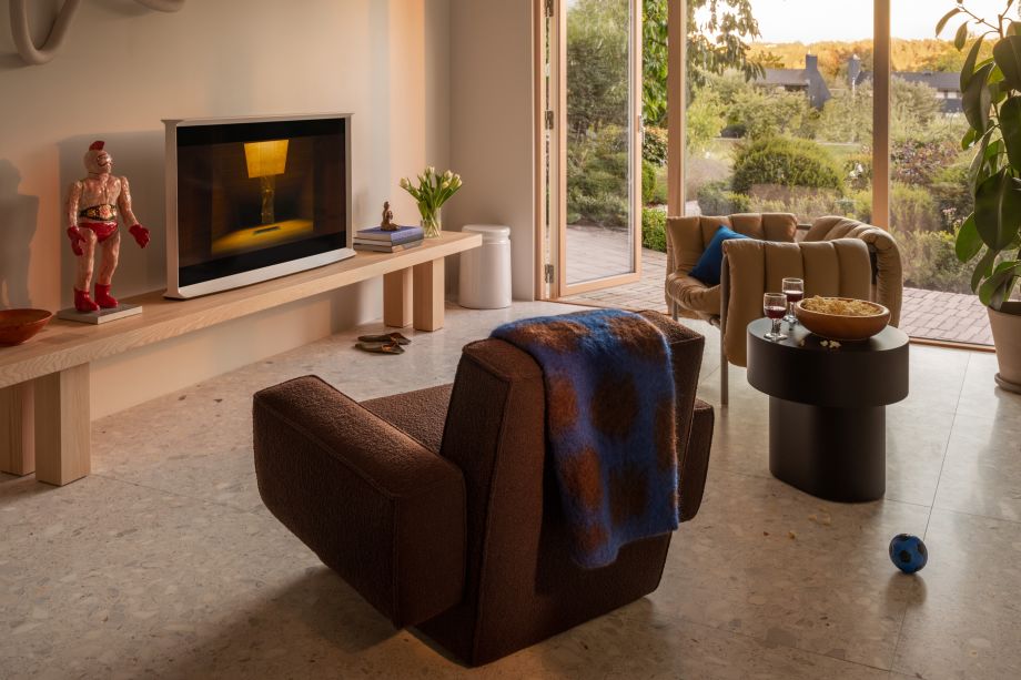 A lifestyle image of a living room scene featuring Max Bench, Last Stool, Hunk Lounge Chair + Armrests, Monster Throw, Puffy Lounge Chair, and Stump Side Table.