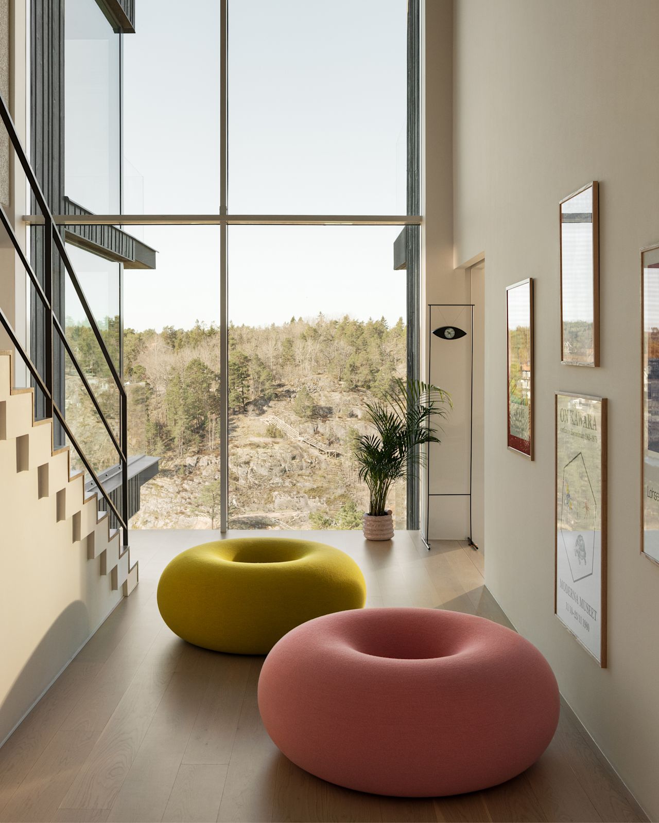 A lifestyle image of a hallway featuring Boa Pouf in Cotton Candy and Sulfur Yellow.