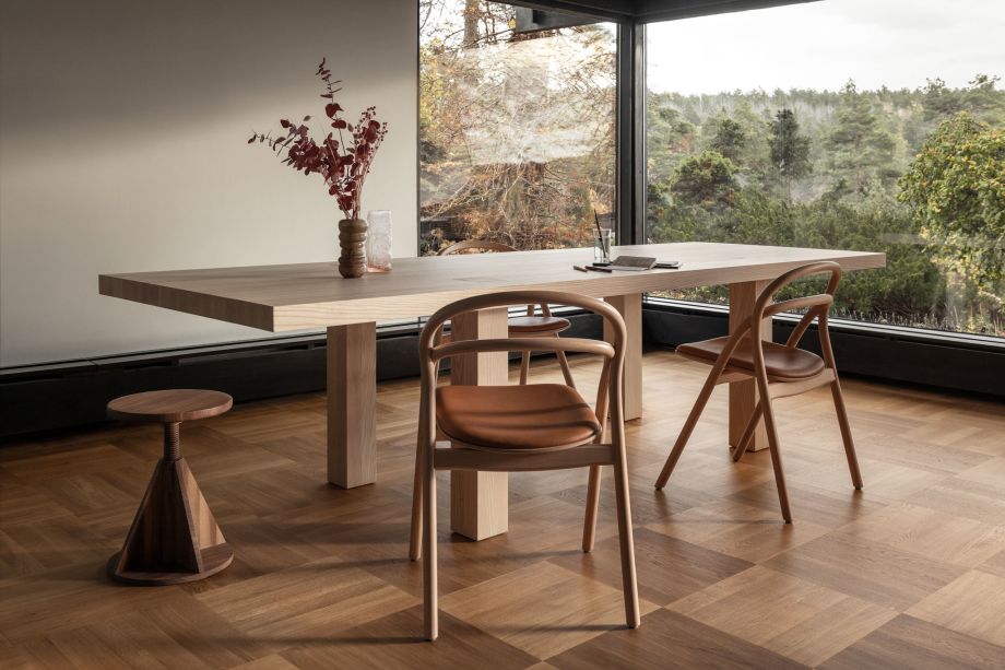 A lifestyle image of a dining scene featuring Max Table, Udon Chairs, and All Wood Stool.