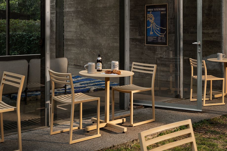 A lifestyle image of an outdoor patio scene featuring Chop Table Round Beige and Chop Chairs Beige.