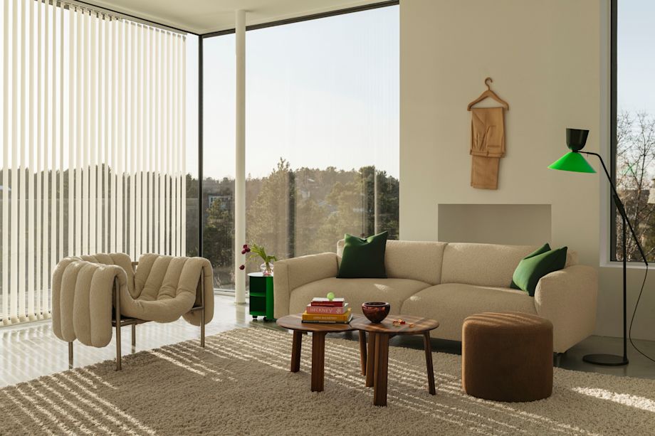 Hem - A living room scene featuring a Puffy Lounge Chair in Eggshell / Stainless Steel, Hide Side Table Pure Green, Koti 3-seater Sofa, Alle Round Coffee Tables Set of 2 Walnut, Bon Pouf Round Brown, and an Alphabeta Floor Lamp.