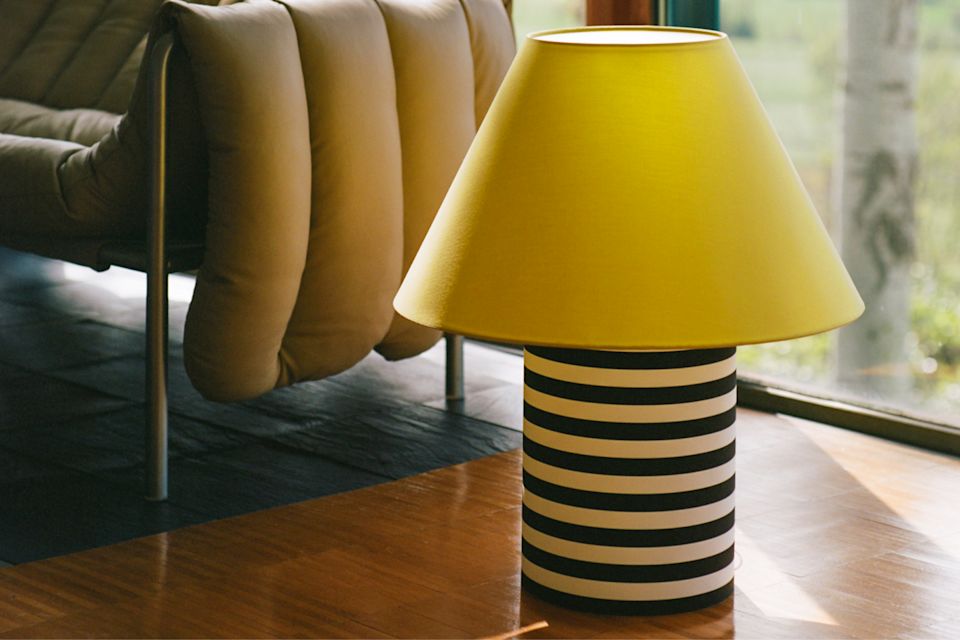 A lifestyle image of a living room/lounge scene featuring Puffy 2.5-seater Sofa and Toto Table Lamp Large.
