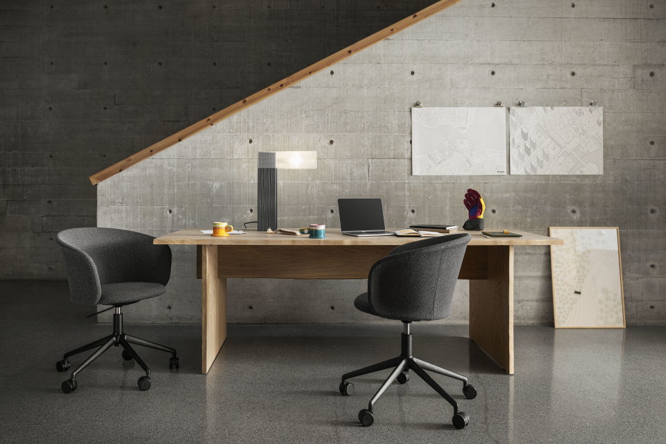 A lifestyle image of an office scene featuring Kendo Swivel Chairs and Bookmatch Table.