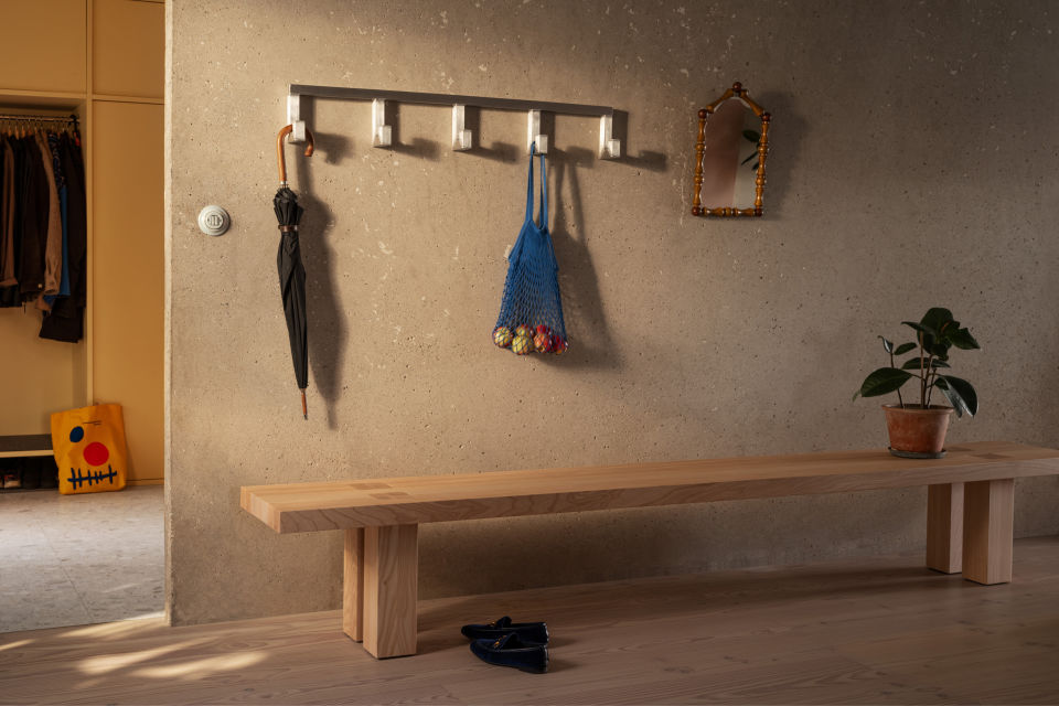A lifestyle image of a hall scene featuring Max Bench and Tig Hook.