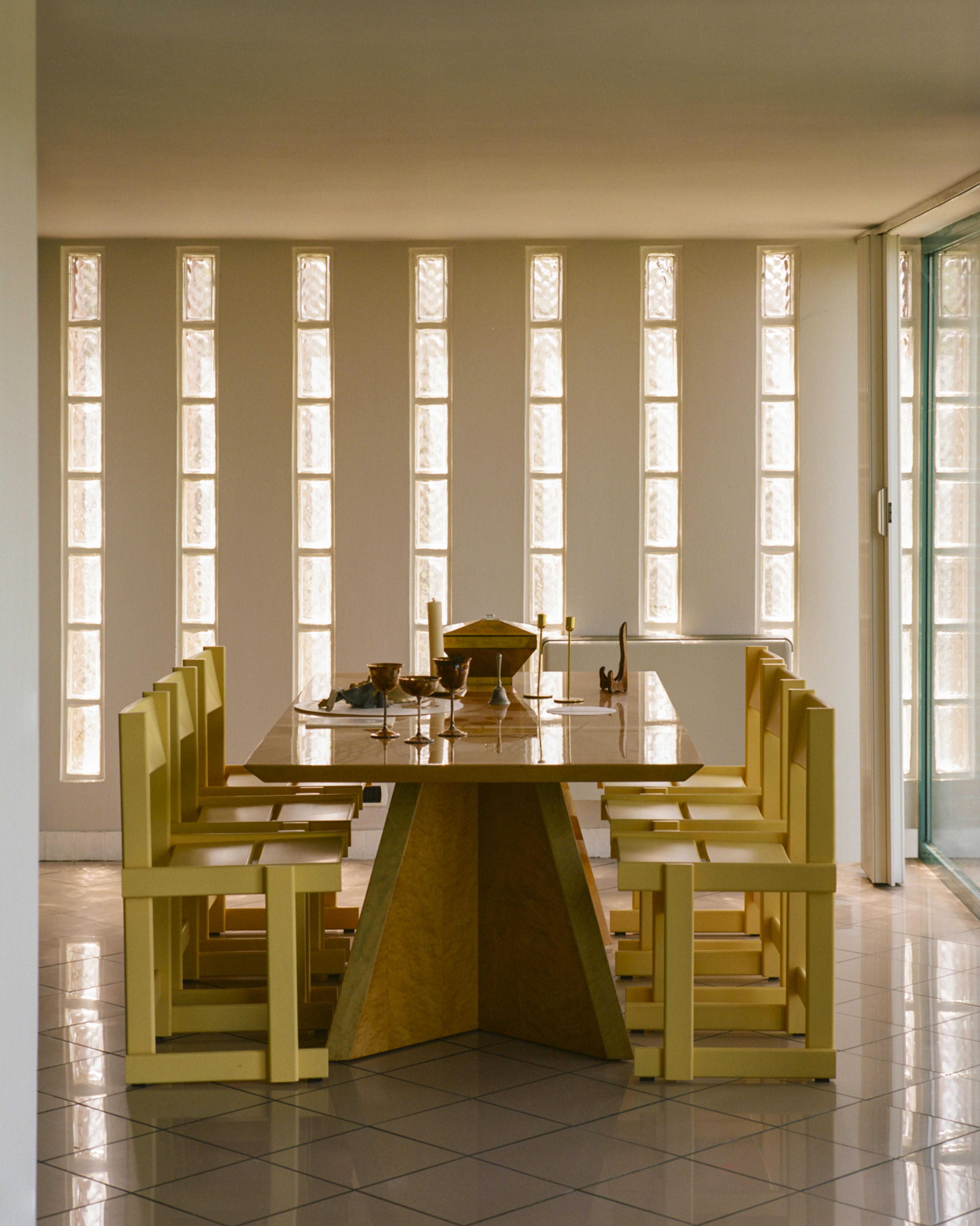 A lifestyle image of a dining scene featuring Bullnose Chairs.