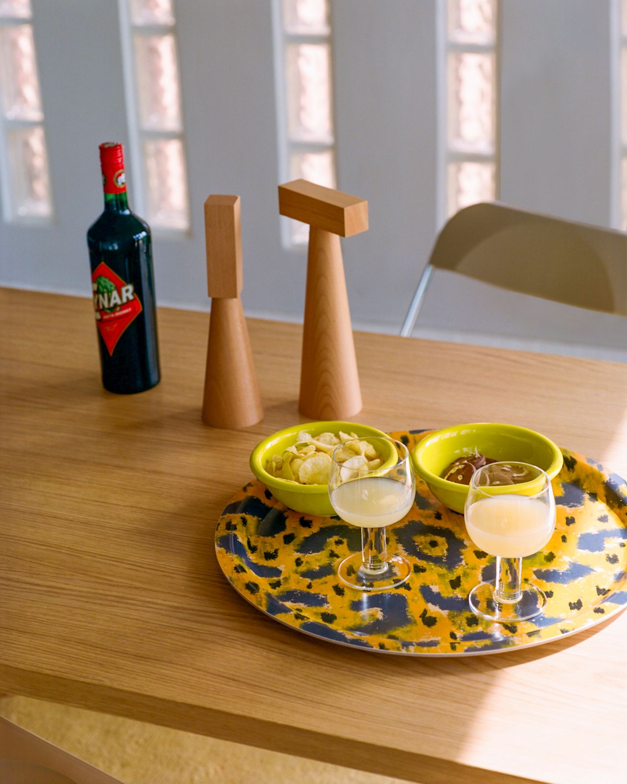 A lifestyle image of a dining scene featuring Molino Grinders, Bronto Bowls, Fars Glas Drinking Glass (Set of 2), and Monster Tray Medium.