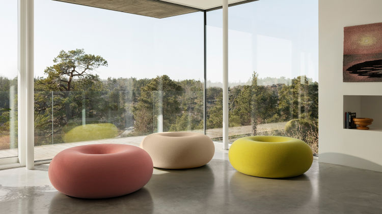 A lifestyle image of a lounge scene featuring Boa Pouf in Cotton Candy, Oatmeal and Sulfur Yellow.
