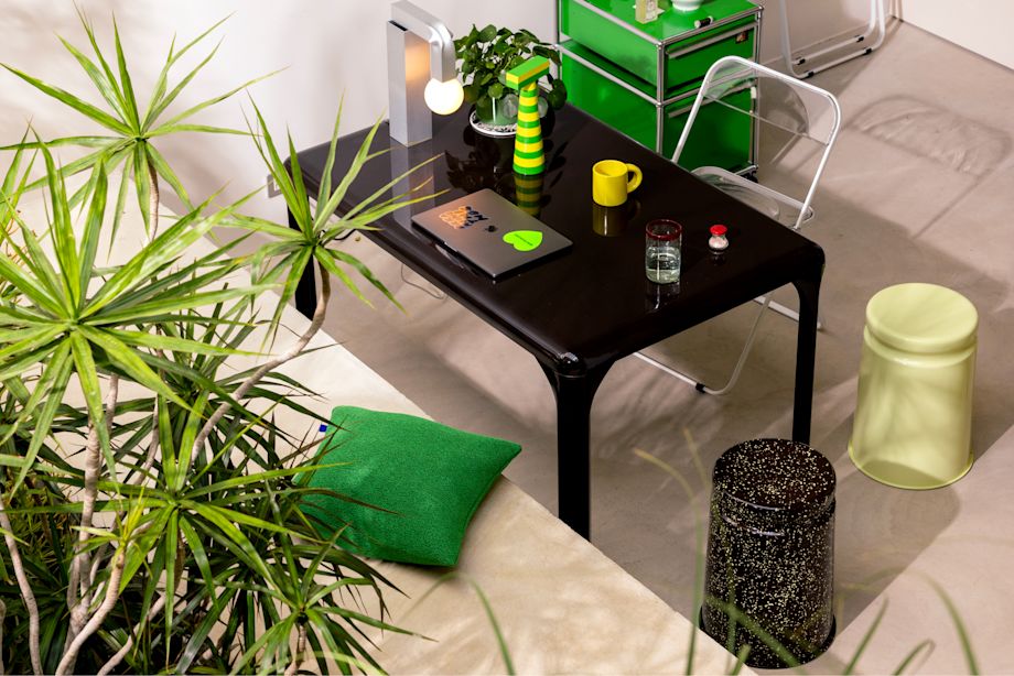 A lifestyle image of an office scene featuring Crepe Cushion, Last Stools, Molino Grinder, Knuckle Table Lamp, and Bronto Mug.