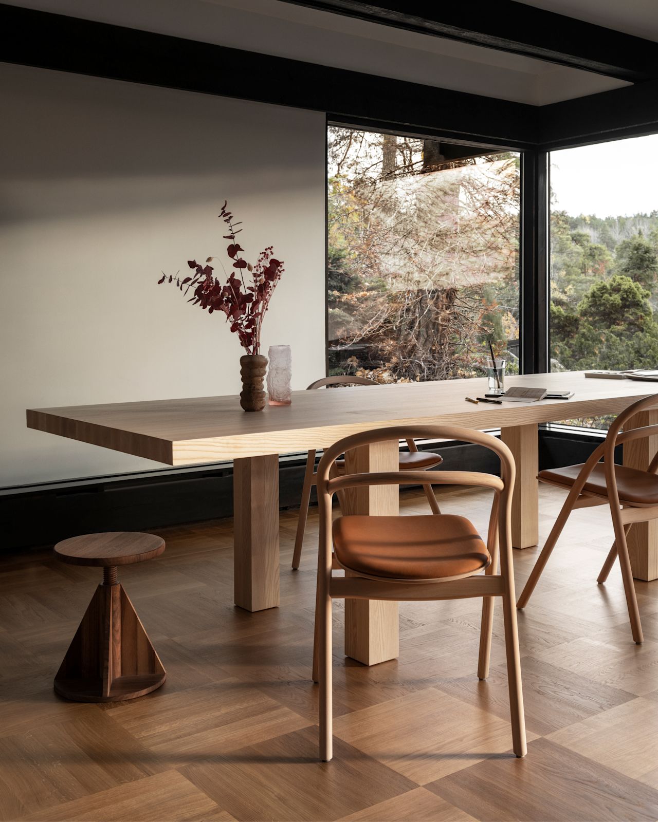 A lifestyle image of a dining scene featuring Max Table, Udon Chairs, and All Wood Stool.