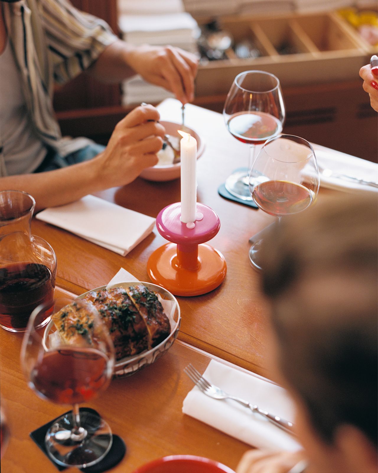 A lifestyle image of a dining/kitchen scene featuring Pesa Candle Holder, Bronto Bowl, and Disco Coasters.