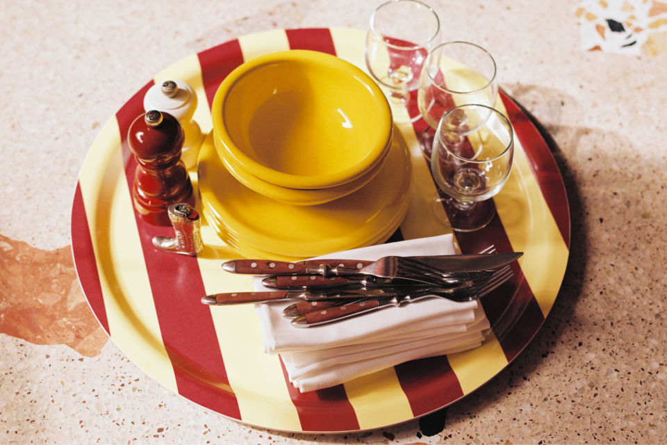 A lifestyle image of a dining scene featuring Stripe Tray and Bronto Tableware.