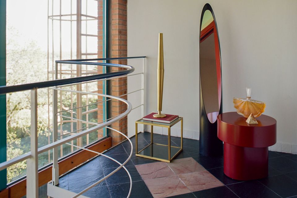 A lifestyle image of a hallway scene featuring Stump Side Table Wine Red.