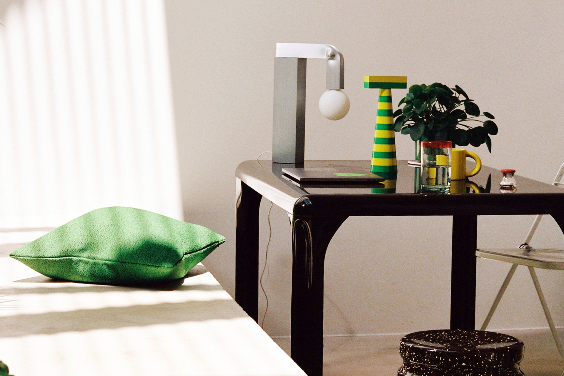 A lifestyle image of an office scene featuring Last Stool, Molino Grinder, Crepe Cushion, Bronto Mug, and Knuckle Table Lamp.