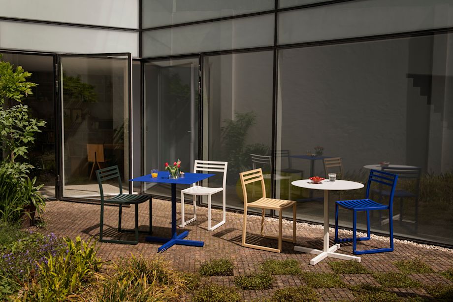 A lifestyle image of a patio scene featuring Chop Tables and Chop Chairs.