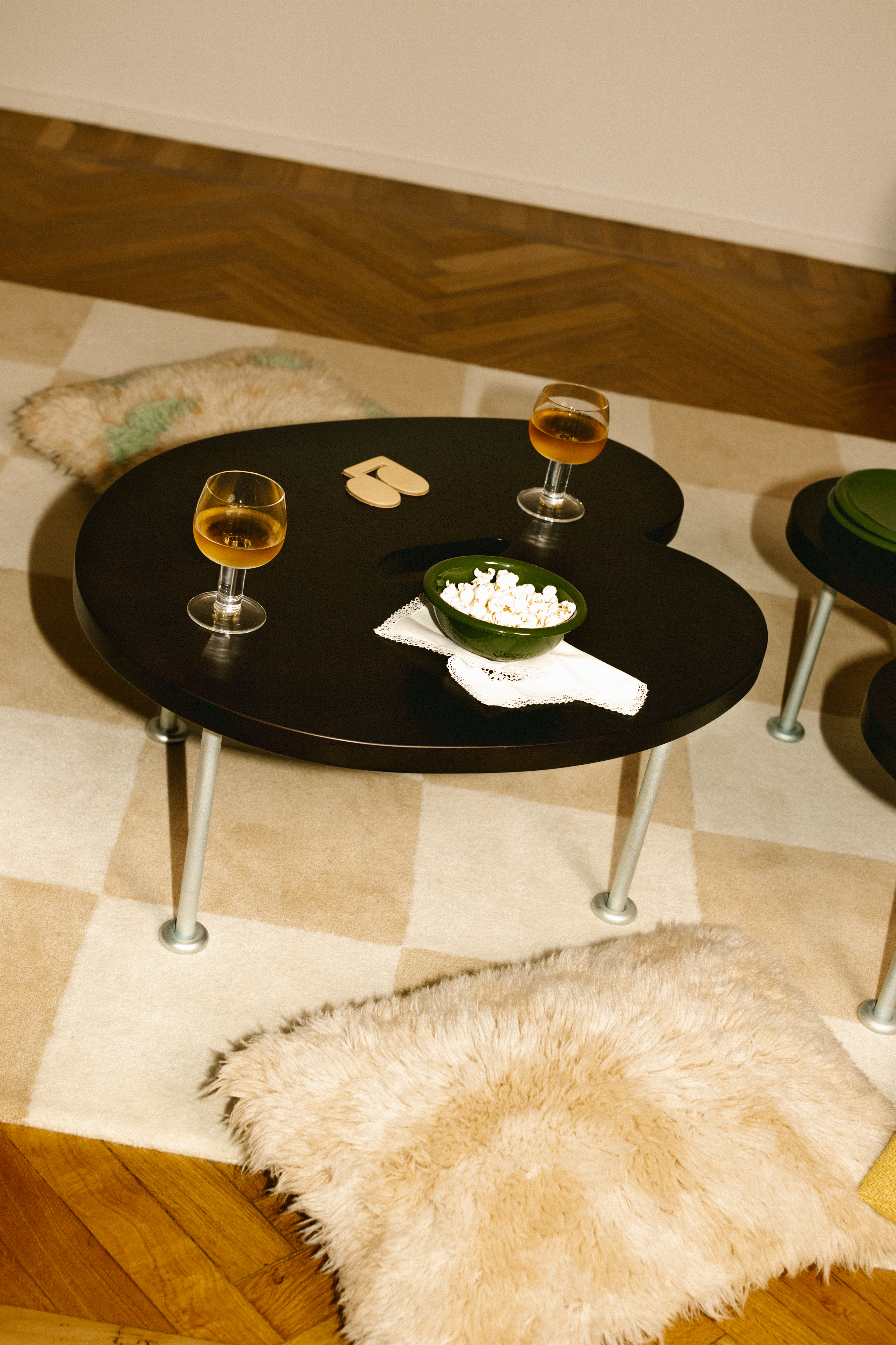 A lifestyle image of a living room/lounge scene featuring Worm Tables, Pattern Rug, Monster Cushions, Fars Glas Drinking Glasses, Disco Coaster, and Bronto Bowl.