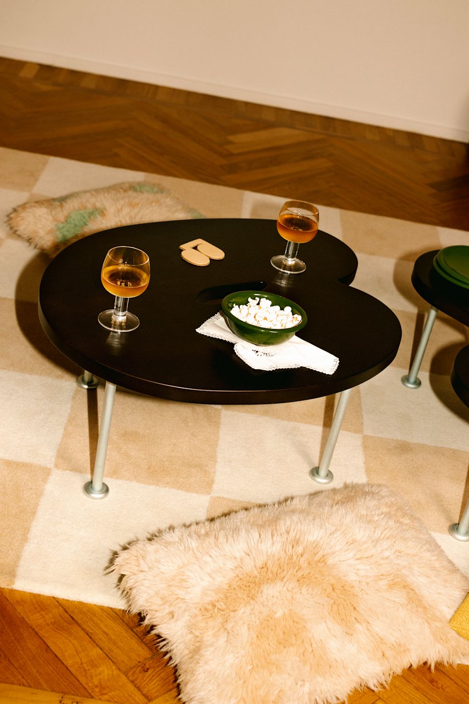 A lifestyle image of a living room/lounge scene featuring Worm Tables, Pattern Rug, Monster Cushions, Fars Glas Drinking Glasses, Disco Coaster, and Bronto Bowl.