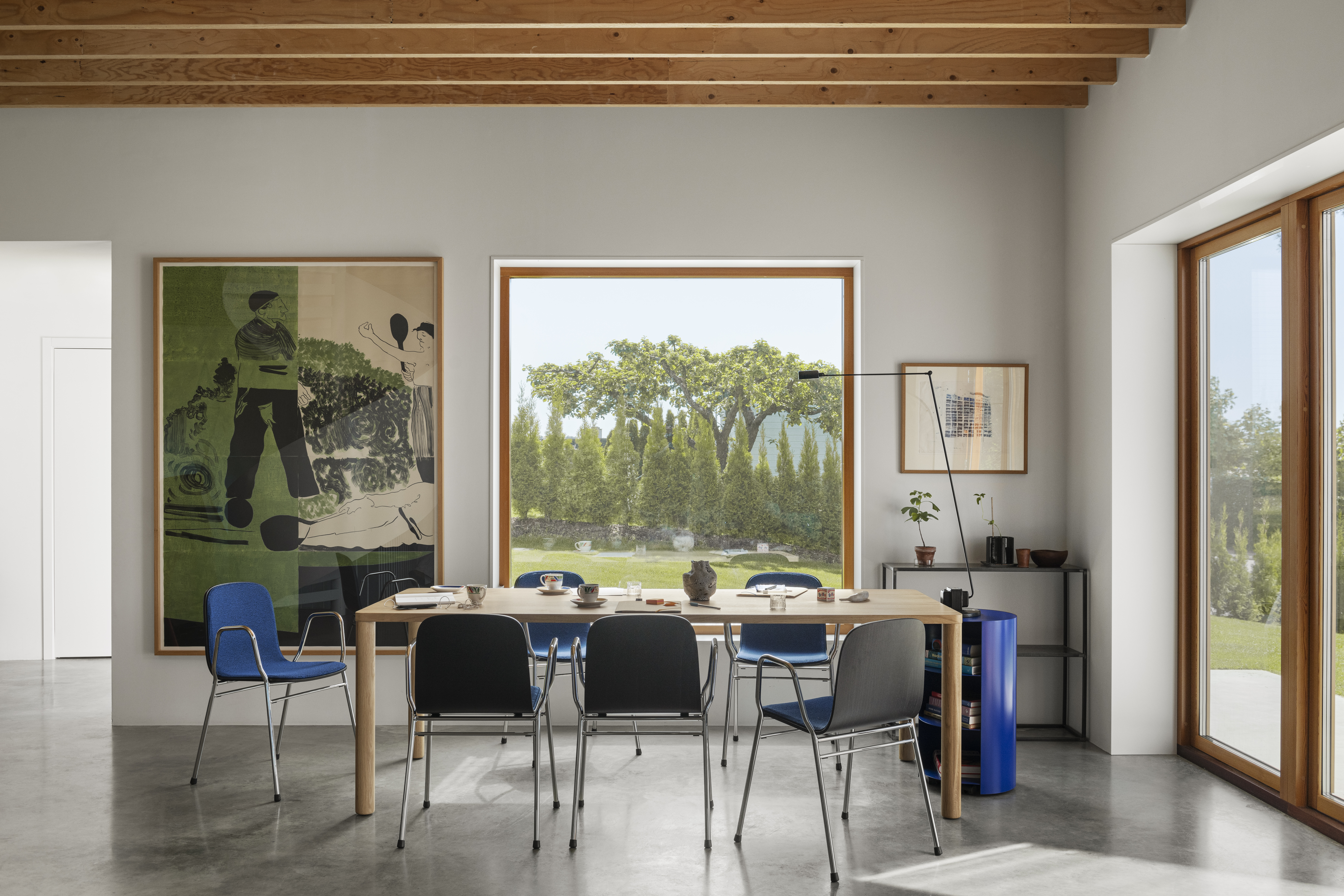 A lifestyle image of a dining room scene featuring Touchwood Armchairs, Log Table, and Hide Pedestal.