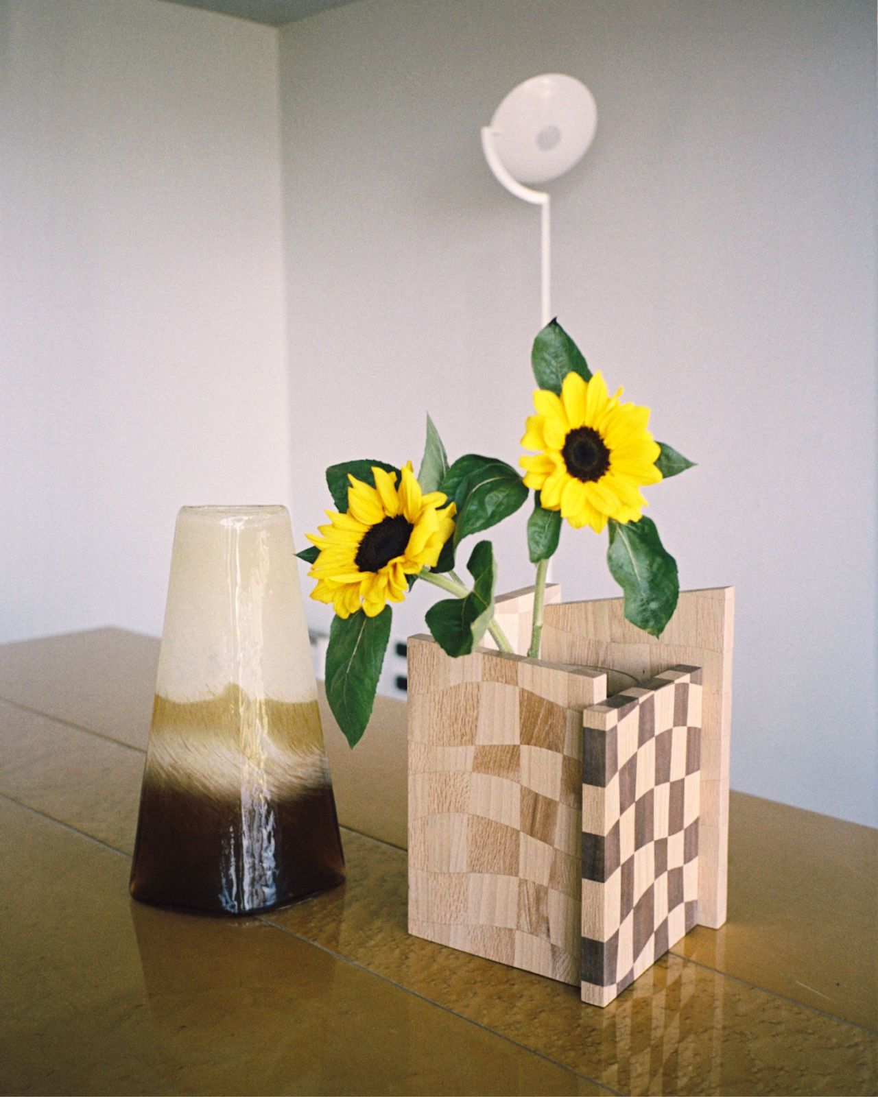 An analog image of a dining scene featuring Mix Wood Vessel, a Hem X limited edition piece.