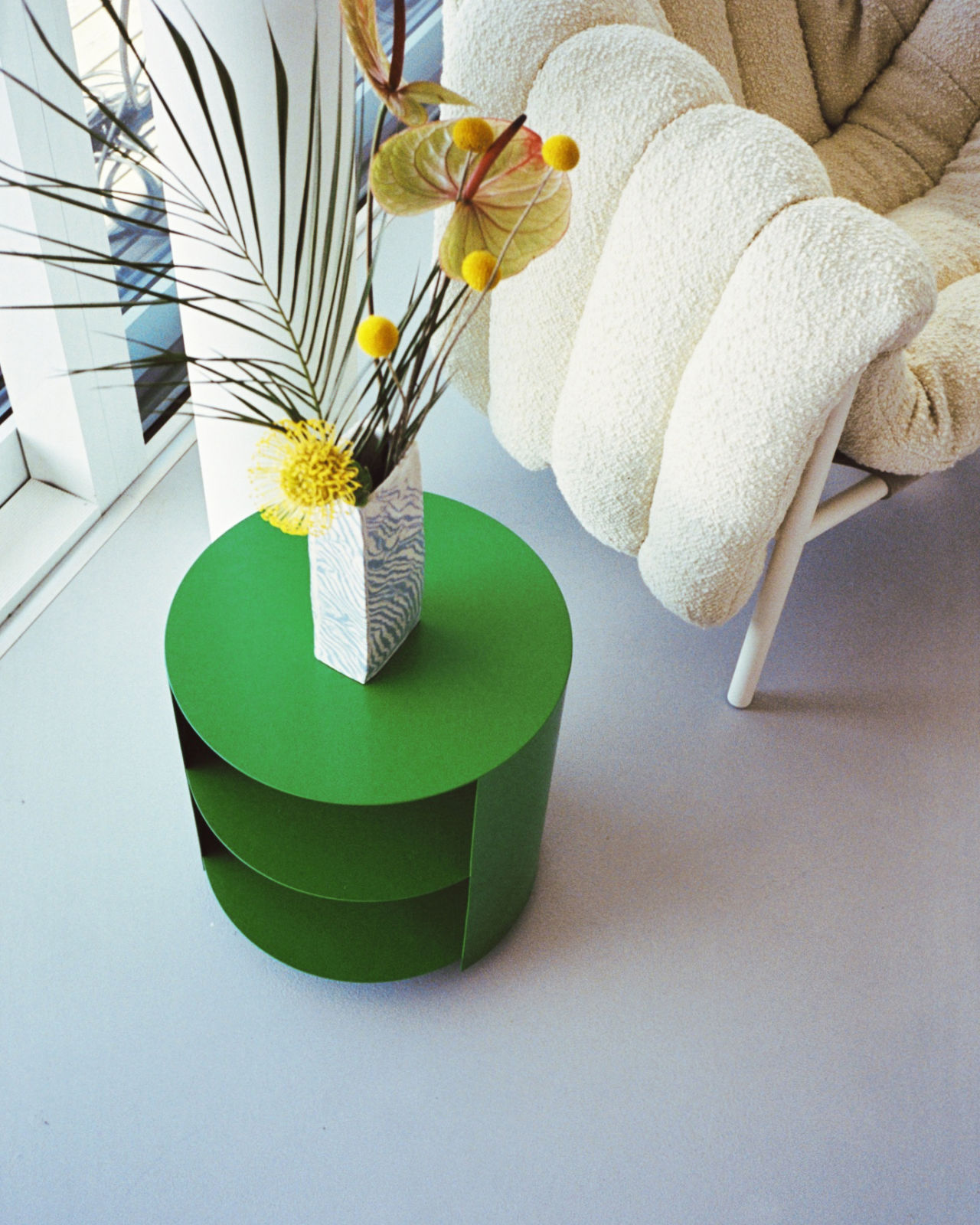 An analog image featuring Hide Side Table Pure Green and Puffy Lounge Chair.