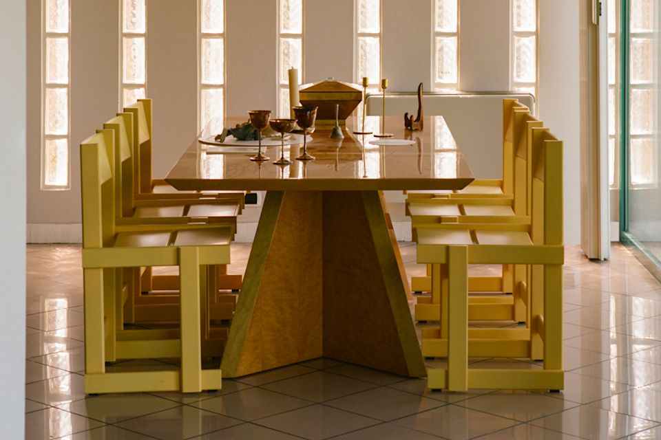 A lifestyle image of a dining scene featuring Bullnose Dining Chairs.
