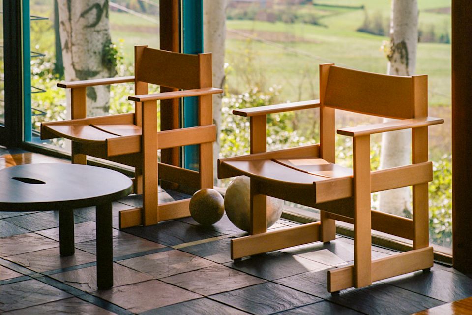A lifestyle image of a lounge scene featuring Bullnose Lounge Chair and Worm Table.