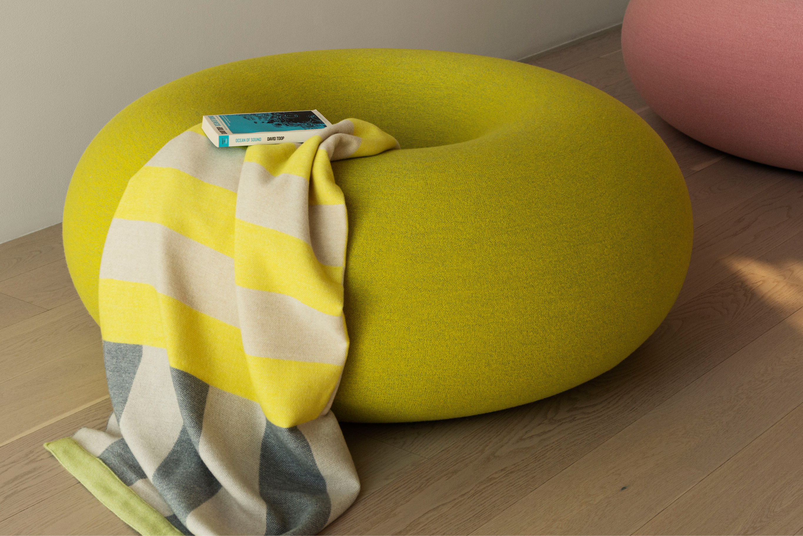 A lifestyle image of a lounge scene featuring Boa Pouf.