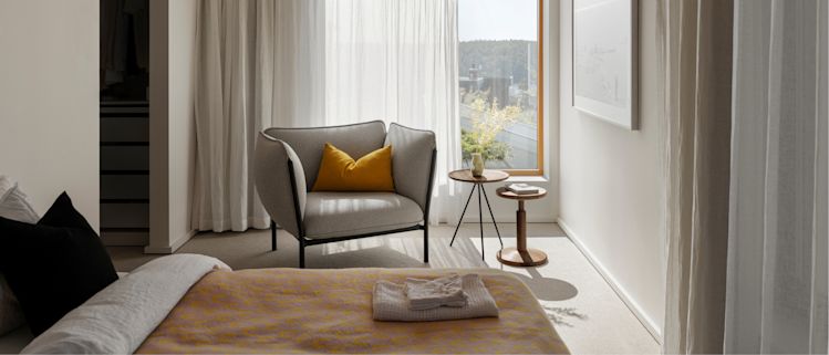 Hem - A bedroom scene featuring Arch Throw, Kumo Single Seater Sofa, Key Side Table, All Wood Stool Bobbin, and Storm Cushion Large.