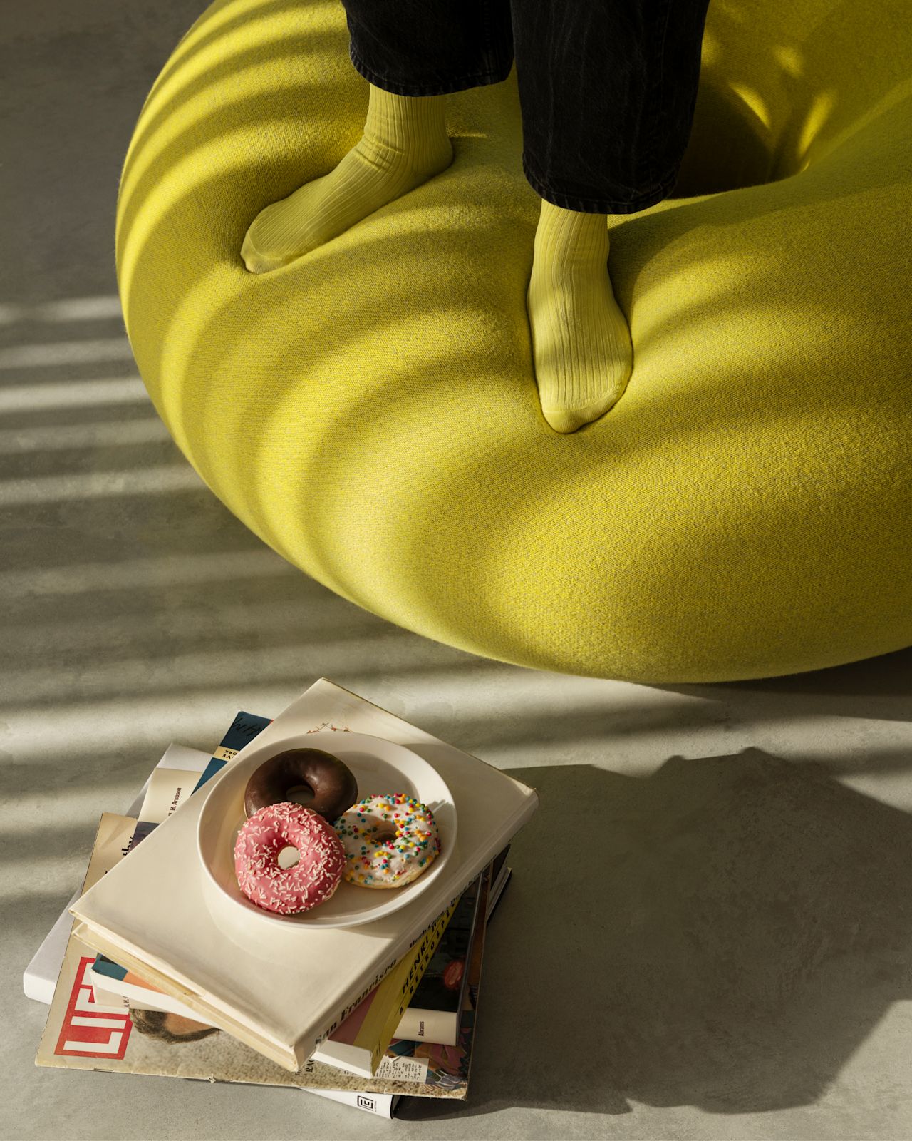 A lifestyle image featuring Boa Pouf Sulfur Yellow.