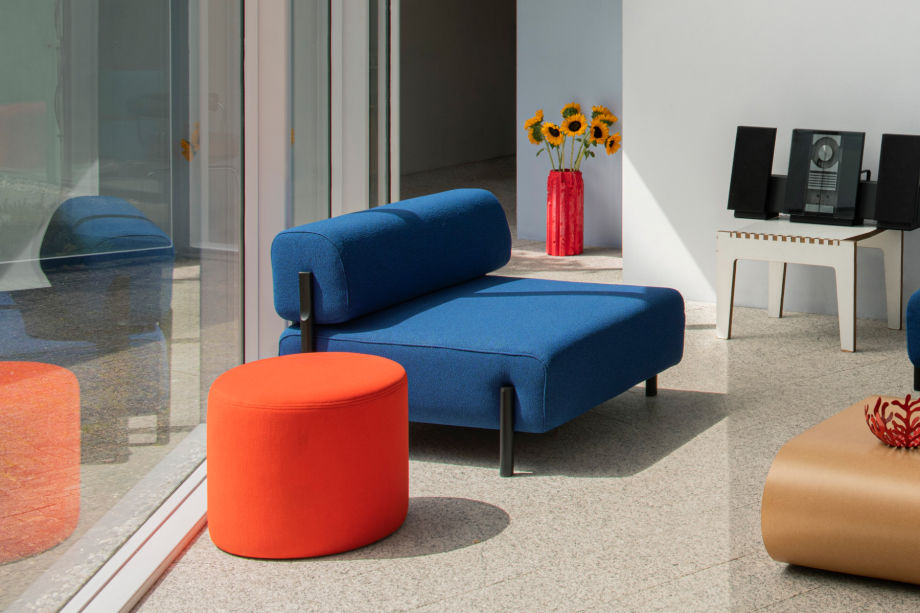 A lifestyle image of a lounge scene featuring Palo Modular Sofa, Stump Coffee Table and Bon Pouf Round.