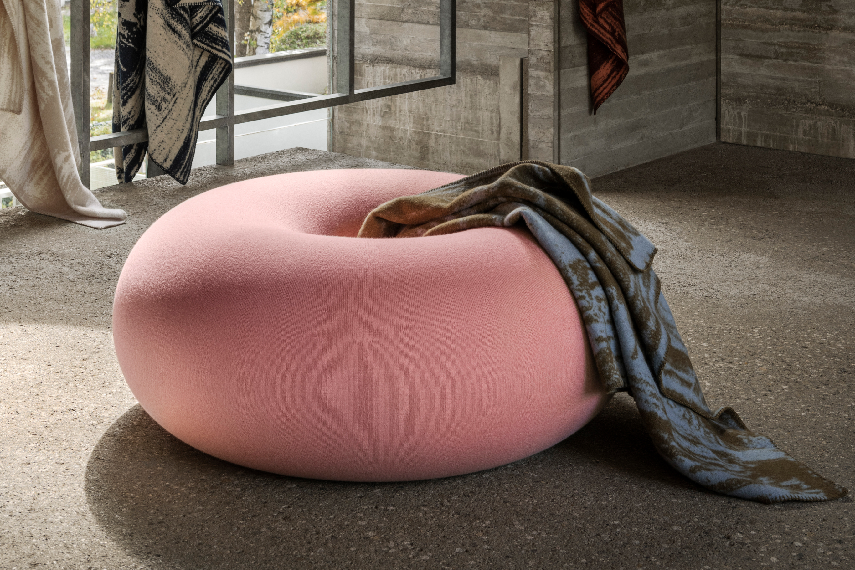 A lifestyle image of a lounge scene featuring Boa Pouf Cotton Candy and Glitch Throw.