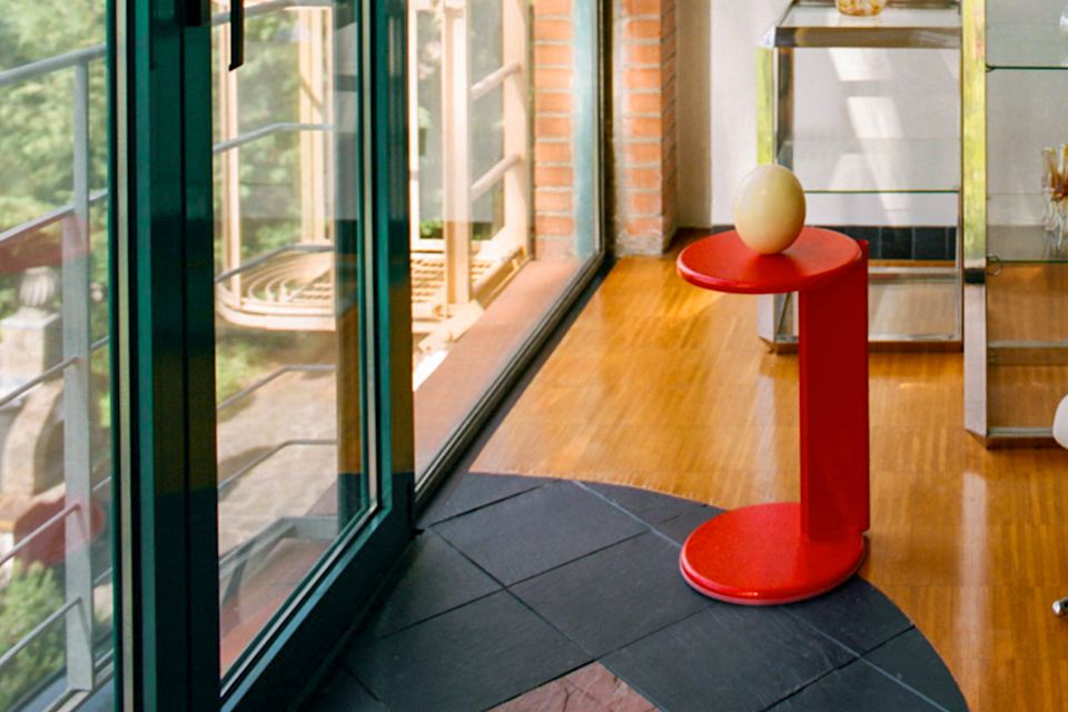 A lifestyle image of a lounge scene featuring Lolly Side Table Traffic Red.