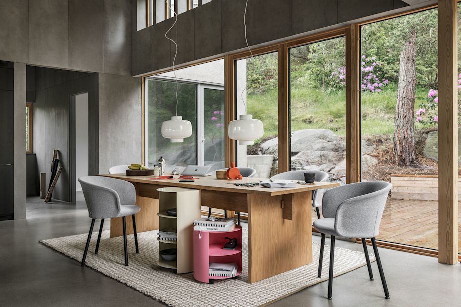A lifestyle image of a dining scene featuring Bookmatch Table, Dusk Lamp, Kendo Chairs, Hide Side Table, Rope Rug, and Hide Pedestal.