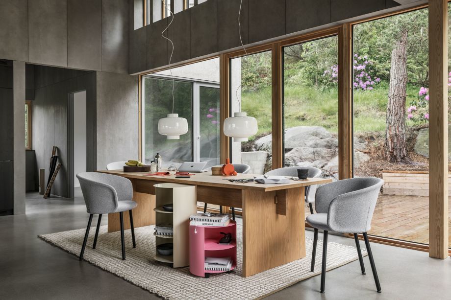 A lifestyle image of a dining scene featuring Bookmatch Table, Dusk Lamp, Kendo Chairs, Hide Side Table, Rope Rug, and Hide Pedestal.