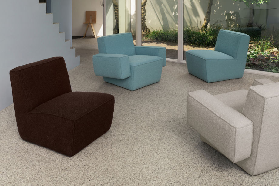 A lifestyle image of a lounge scene featuring Hunk Lounge Chair and Hunk Lounge Chair with Armrests.