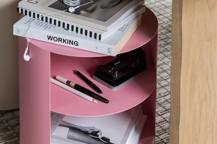 Hem - A Hide Side Table Light Pink being used as a storage for books, pens and more on top of a Seaweed Rope Rug.