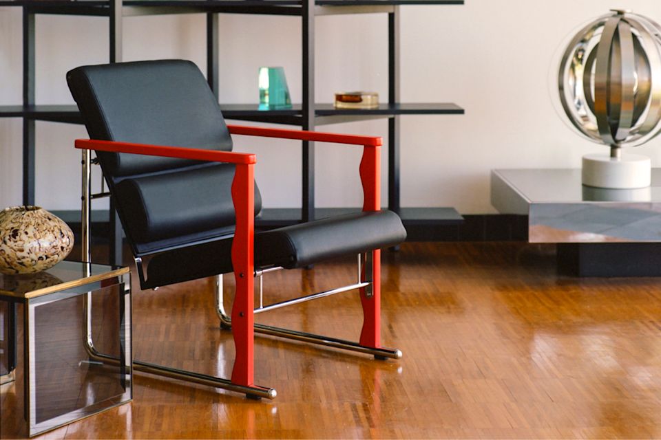 A lifestyle image of a lounge scene featuring Experiment Lounge Chair and Zig Zag Shelf High.