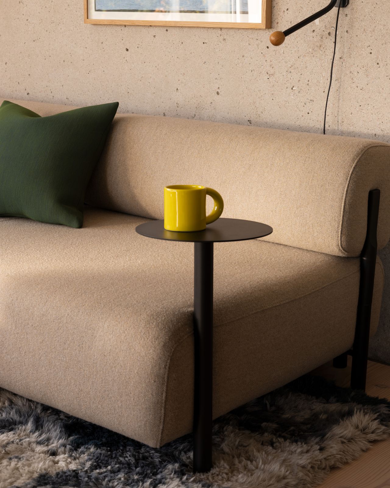 A lifestyle image of a living room scene featuring Neo Cushion, Palo Modular Sofa, Palo Side Table, Bronto Tableware, and Monster Rug.