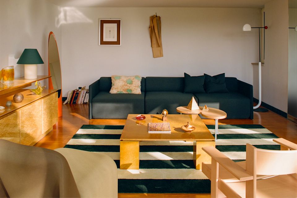 A lifestyle image of a living room/lounge scene featuring Palo Block Sofa, Toto Table Lamp, Pattern Rug, Monster Cushion Large, Worm Table, and Bullnose Lounge Chair.