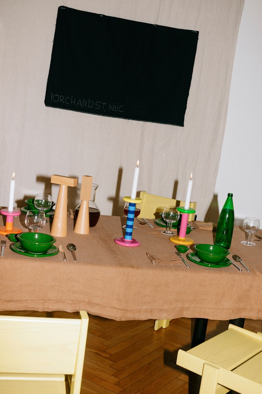 A lifestyle image of a dining scene featuring Pesa Candle Holders, Molino Grinders, Bronto Tableware, Bullnose Chairs, and more.