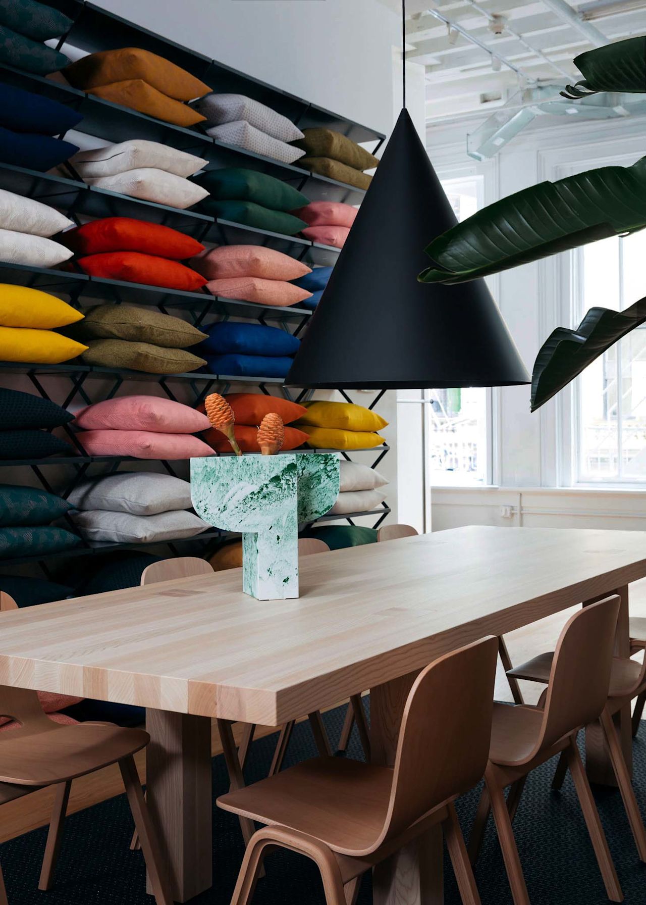 An editorial image from Hem's NYC studio / showroom featuring Powder Vase, Touchwood Chairs, Storm Cushions and Max Table.