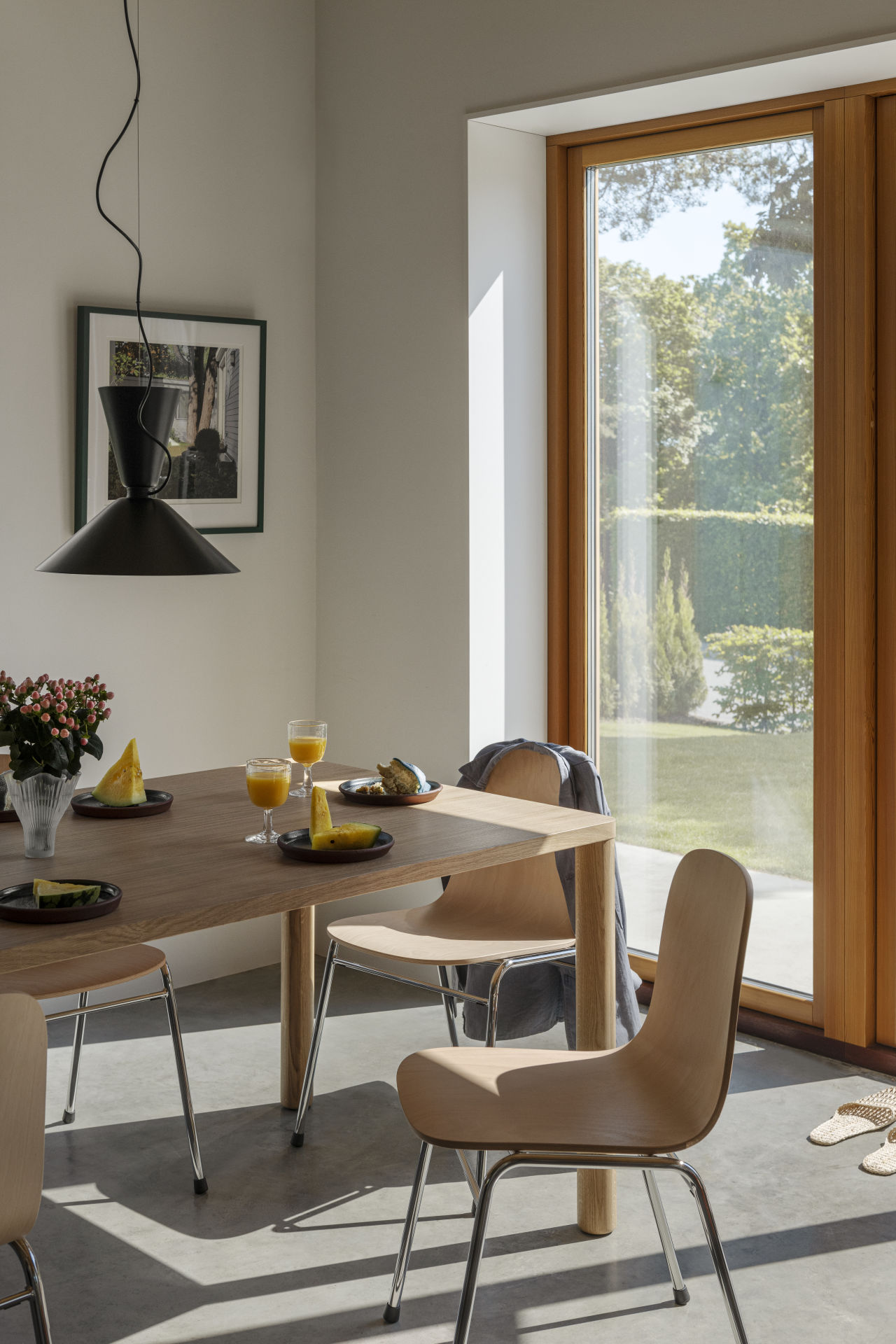 A lifestyle image of a dining / kitchen scene featuring Alphabeta Pendant Light, Log Table and Touchwood Chairs.