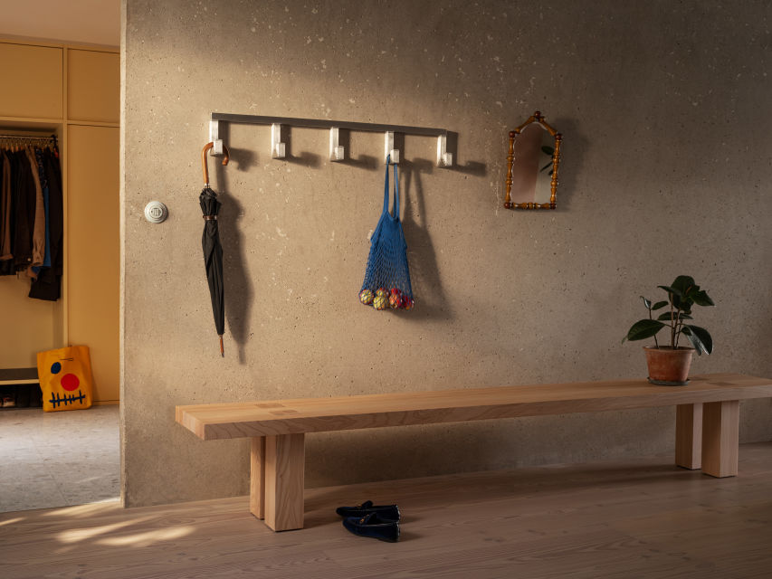 A lifestyle image of a hallway featuring Tig Hook Quintuple and Max Bench.