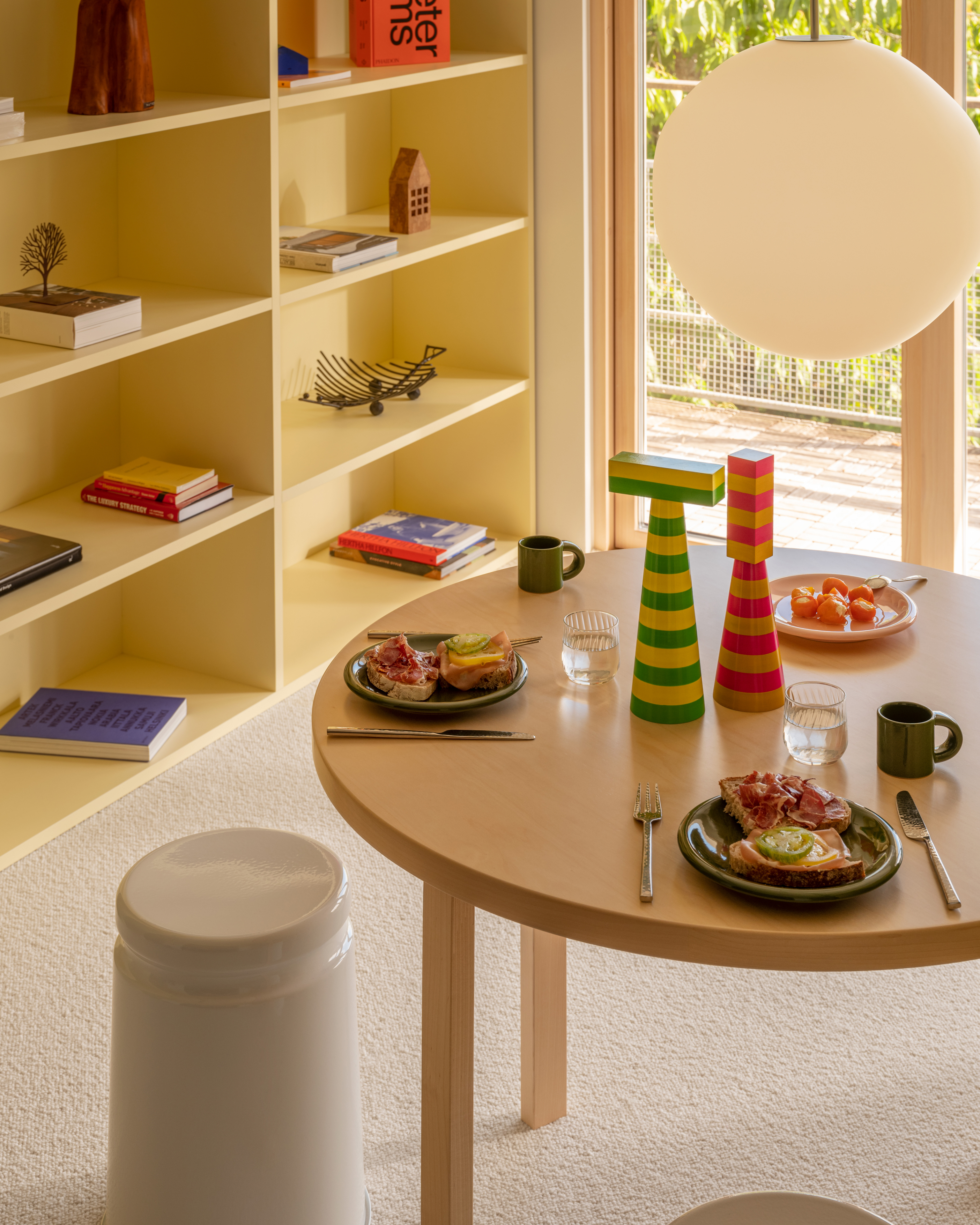A lifestyle image of a dining scene featuring Coco Pendant Light, Last Stool, Bronto Tableware, and Molino Grinder.