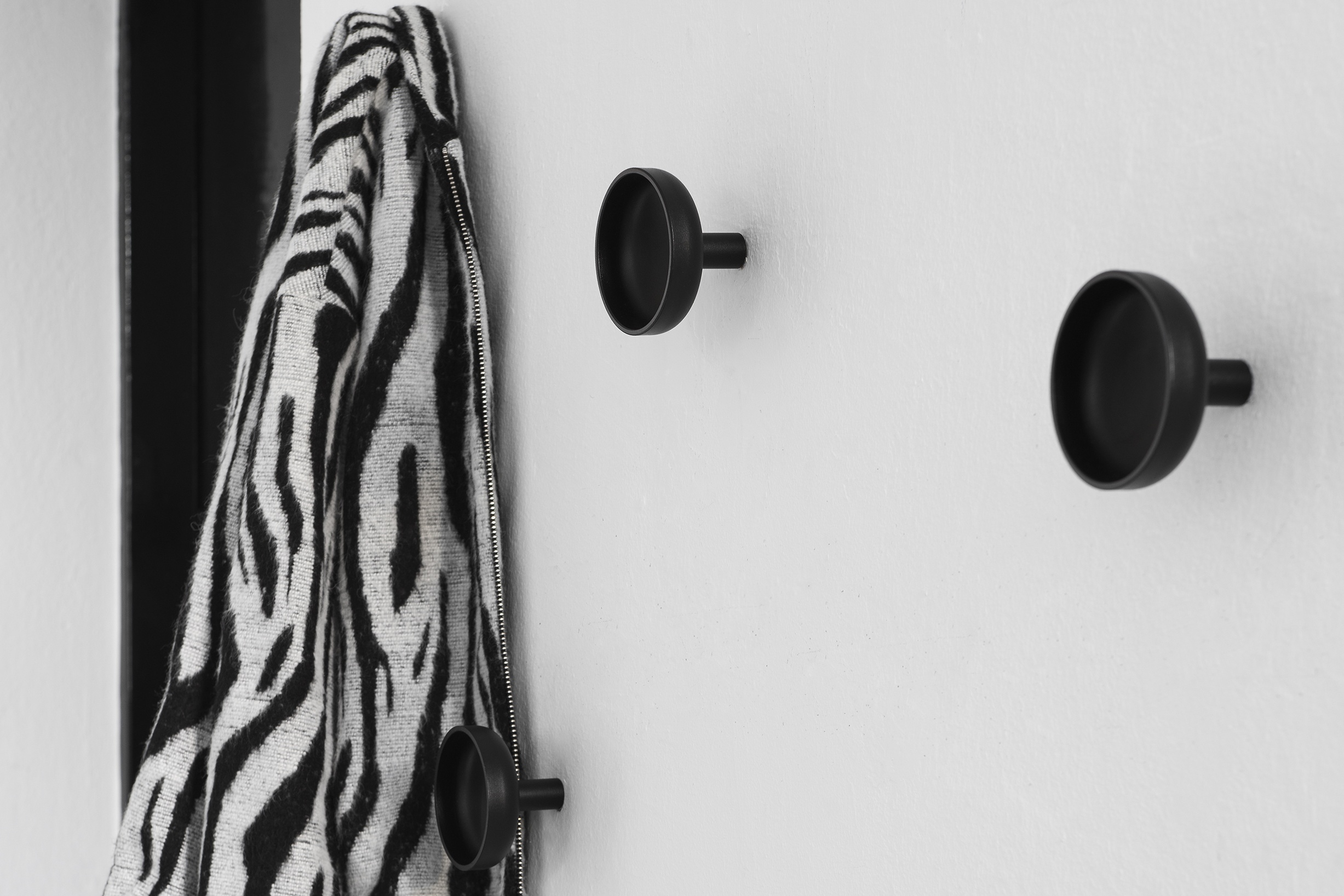 Hem - A lifestyle image featuring Punched Metal Hooks in Black.