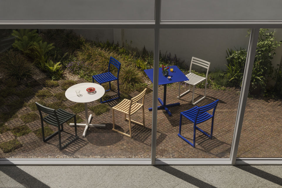 A lifestyle image of a patio scene featuring Chop Table Round, Chop Table Square, and Chop Chairs.
