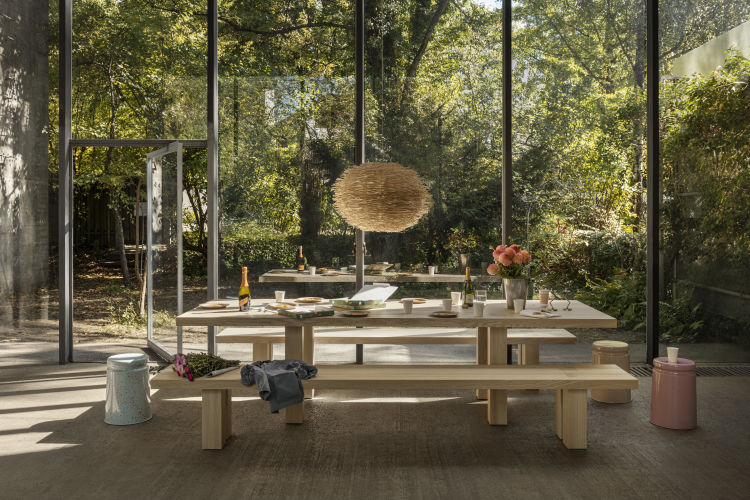 A lifestyle image of a dining scene featuring Max Table, Max Benches, and Last Stools.