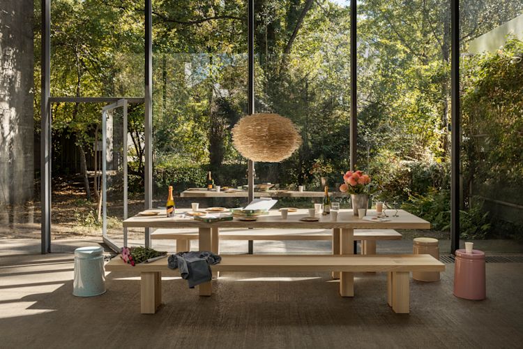 A lifestyle image of a dining scene featuring Max Table, Max Benches, and Last Stools.